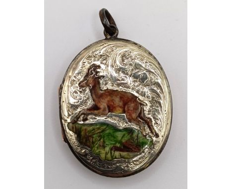 An early 20th century silver gilt and enamel oval locket