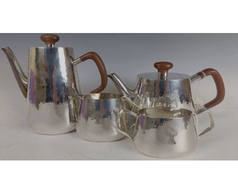 A Elizabeth II silver four piece tea set, with hammered decoration and engraved a bushel of wheat, comprising of a teapot, co