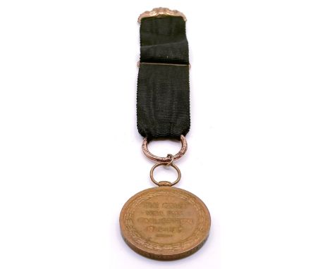 A WWI Victory medal, engraved for his wife, on a silk and yellow metal cloth