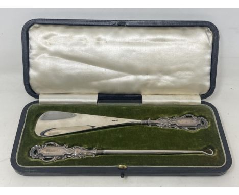 A shoehorn and matching button hook, with silver mounts, cased, and a set of six coffee spoons, cased (2)