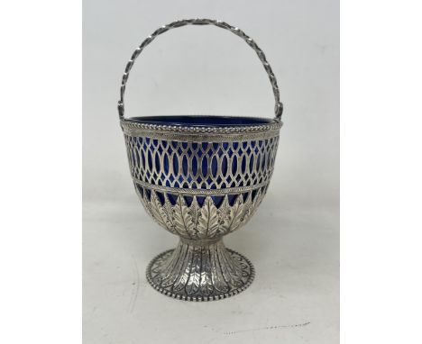 An early 19th century silver swing handle basket, marks rubbed, 4.4 ozt, with a blue glass liner