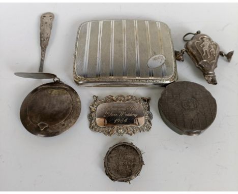 A silver coloured metal cigarette case, two compacts, a baby's rattle, a wine label, a silver coin mounted as a brooch, a bab