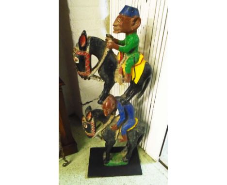 TRIBAL ARTS, a Bamana painted and carved wooden post from a carnival marionette, horses and riders, 106cm H.