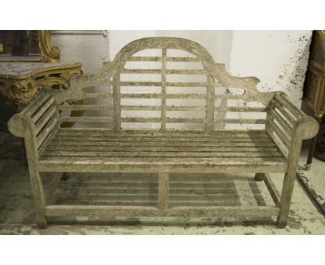 LUTYENS STYLE GARDEN BENCH, vintage weathered silvered teak after a design by Edwin Lutyens, arched and slatted, 165cm W.