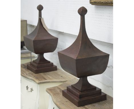 URNS, a pair, decorative bronze effect on square bases, 62cm H. (2)