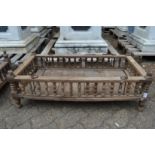 An Indian hardwood rectangular cradle or plant trough with turned spindle supports.