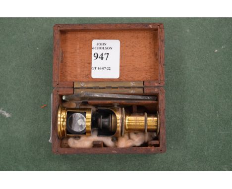 A miniature microscope in a mahogany case.