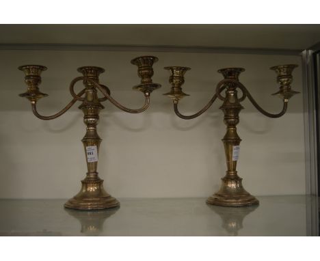 A pair of plated three light candelabra.