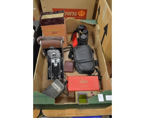 A Polaroid land camera model 95 and other camera equipment.