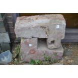 Two architectural stone elements.