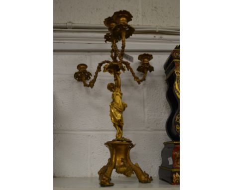 An ormolu three-branch, four-light figural candelabra.