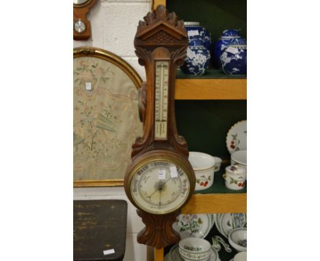 A large Victorian oak framed barometer / thermometer.