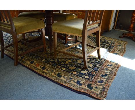 A Persian carpet, blue ground with stylized decoration depicting trees and animals etc. 265cms x 180cms.