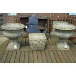A pair of composite garden urns and a square shaped planter.