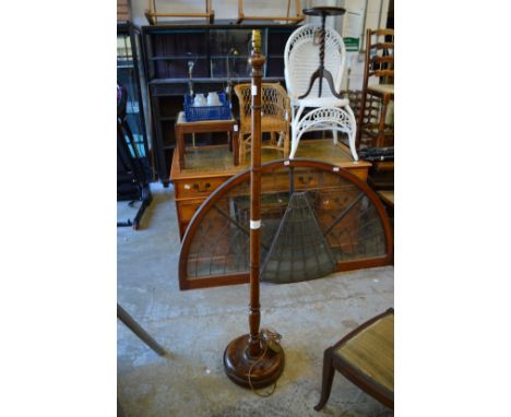 A wooden standard lamp.