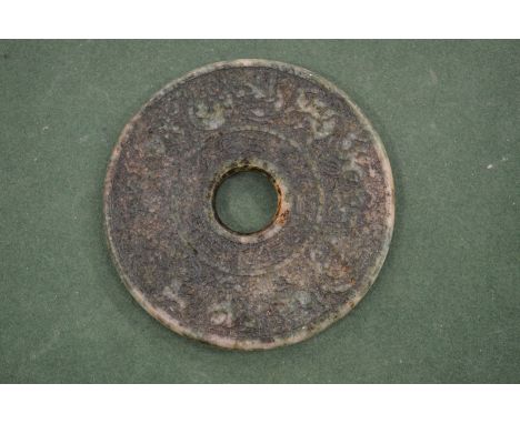 A Chinese carved nephrite / jade archaic style bi disc.