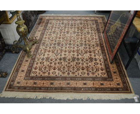 A beige ground Persian style carpet 230cms x 170cms.