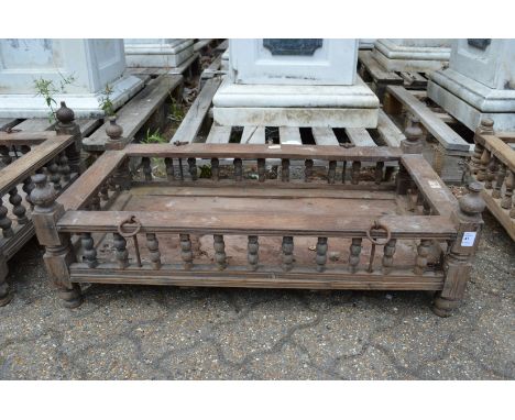 An Indian hardwood rectangular cradle or plant trough with turned spindle supports.