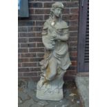 A large composite garden statue of a young lady.