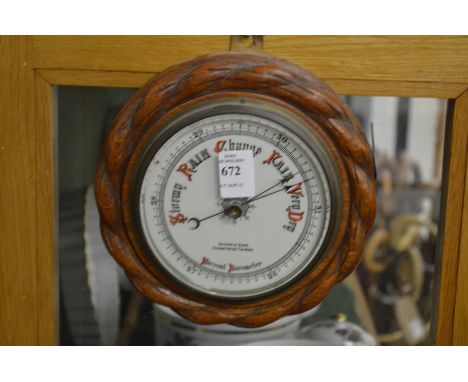 A small circular aneroid barometer.