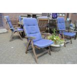 A set of six hardwood reclining armchairs.