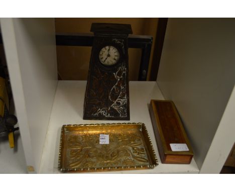 An Art Nouveau embossed brass tray, a similar mantle clock and another item.