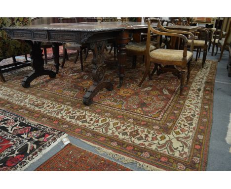 A good large Persian design carpet, rust ground with stylized floral decoration 360cms x 310cms.