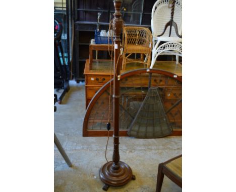 A wooden standard lamp.