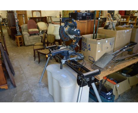 A sliding bevel compound mitre saw with folding leg assembly and extending roller supports.