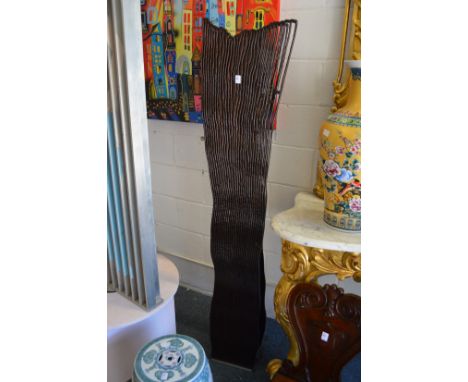 An unusual modern floor standing lamp of pierced and carved wood form.