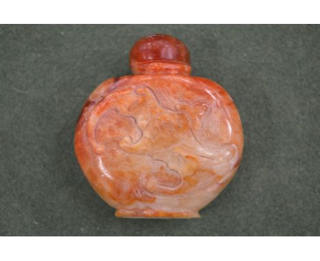 A Chinese carved russet jade bat snuff bottle.