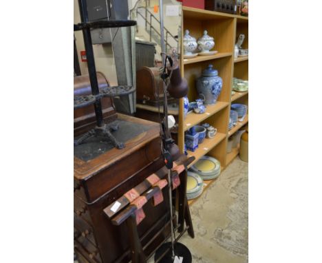 A folding luggage stand, a lamp and a mirror.