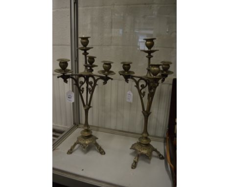 A pair of decorative four light, three branch candelabra.