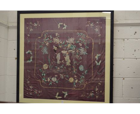 A large Chinese embroidered panel, framed and glazed.