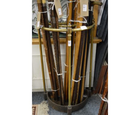 A brass and cast iron demi-lune stick stand.