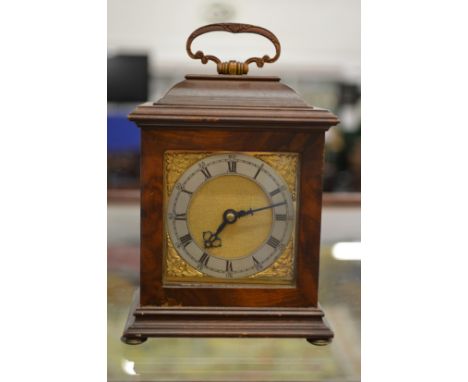 A miniature walnut bracket clock.