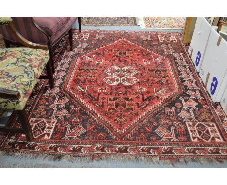 A Persian carpet, red ground decorated with various animals and birds 230cms x 180cms.