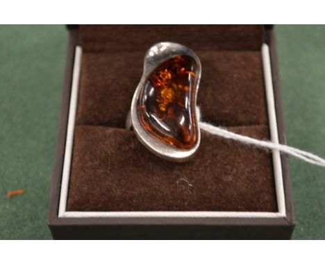 A modern silver and amber ring.