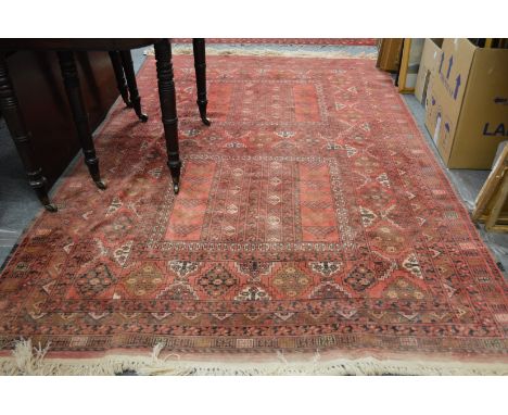 A Persian carpet, red ground with stylized decoration 255cms x 165cms.