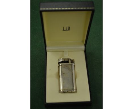 A boxed Dunhill lighter.