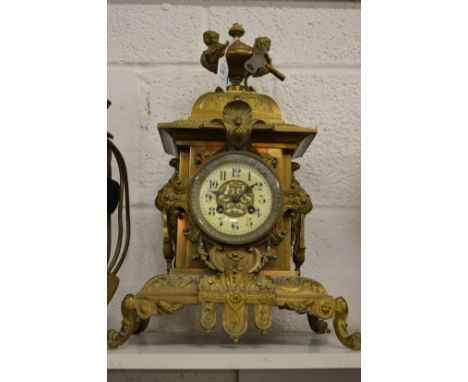 An ornate Victorian brass mantle clock.