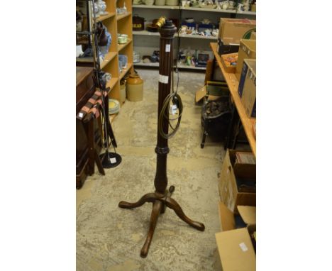 A wooden standard lamp.