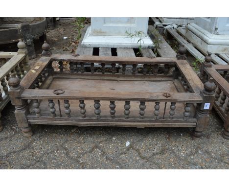 An Indian hardwood rectangular cradle or plant trough with turned spindle supports.