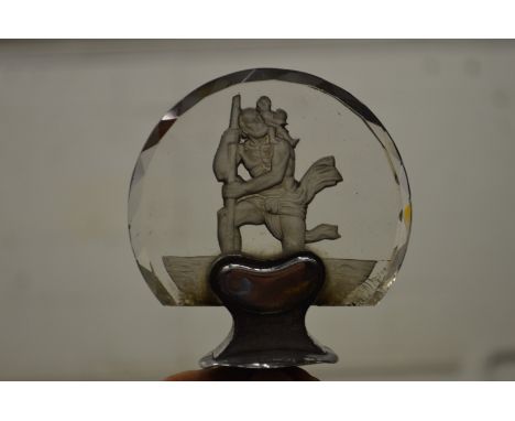 An intaglio carved glass car mascot St. Christopher.