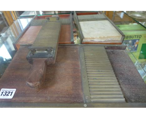 Three chemist pill roller boards with one pill, one roller 