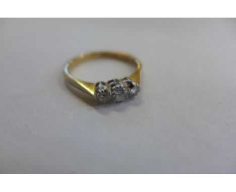 An 18ct and platinum three stone diamond ring, size K/L, approx 2.3 grams, diamonds bright - some usage marks 