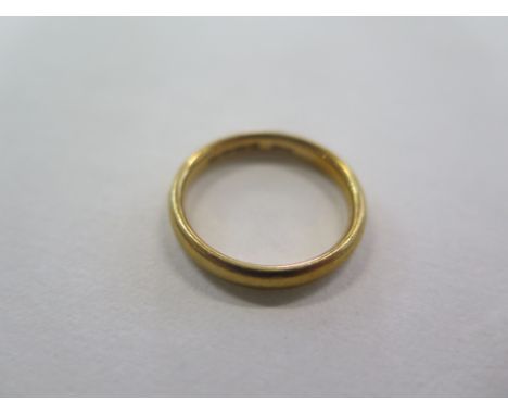 A 22ct gold ring, size N, approx 4.3 grams, in good condition but some usage marks 