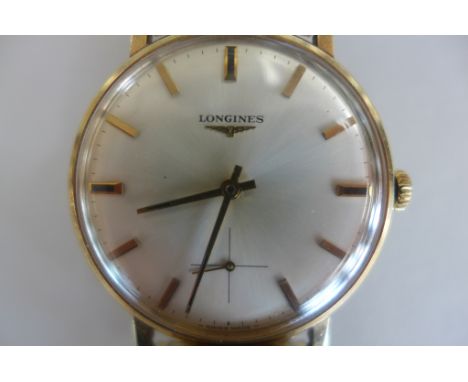 A Longines 9ct yellow gold presentation, manual wind gents wristwatch on a plated sprung strap, 38mm wide including button 