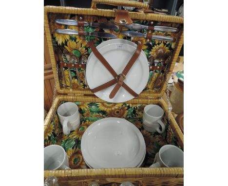 a picnic hamper wicker with ceramic set