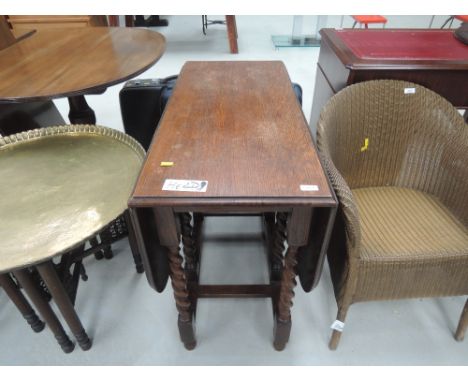 An early to mid 20th Century oak twist gate leg dining table